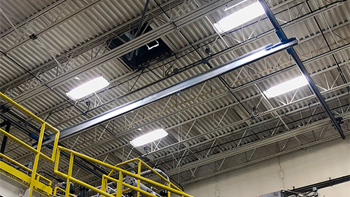 Gorbel ceiling-mounted tether track bridge system inside water treatment plant.