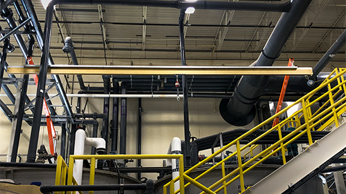 Rigid rail horizontal lifeline over water treatment tanks.