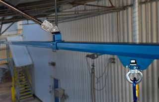 Overhead horizontal lifeline for offloading terminals at a chemical facility.